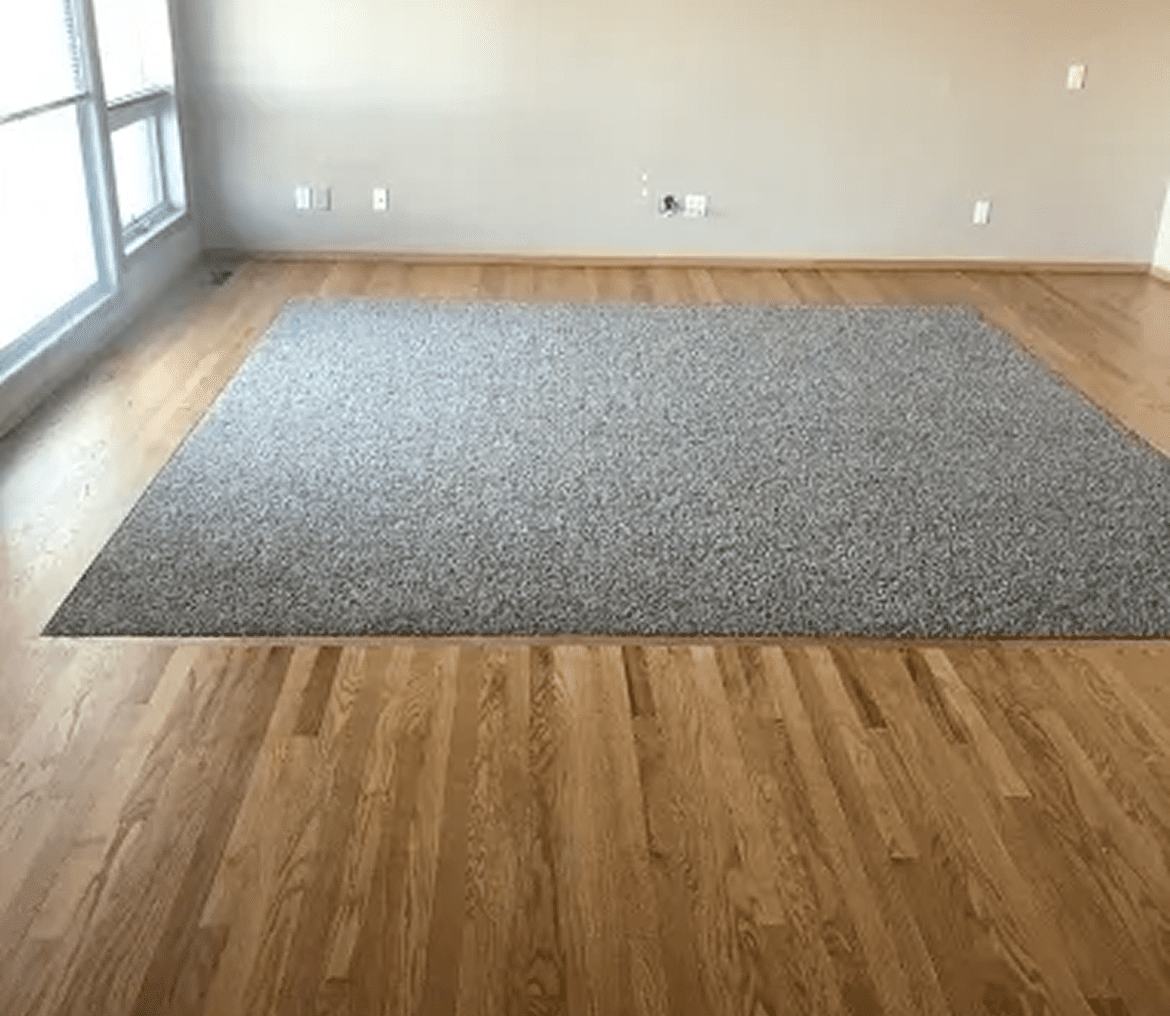 Large rug on wooden floor.